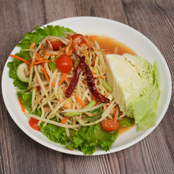 Luv2eat Thai Bistro's Som Tum, a vibrant papaya salad with tomatoes, dried shrimp, and cabbage.